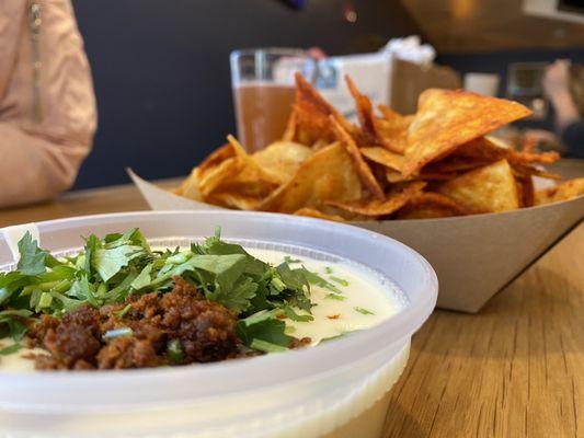 Chips and queso. Pro tip: ask for less seasoning on the chips!