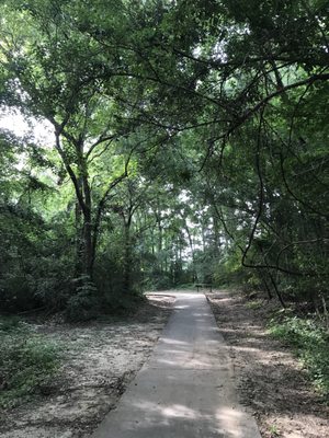 The jogging/biking trail winds along the creek and through the woods.