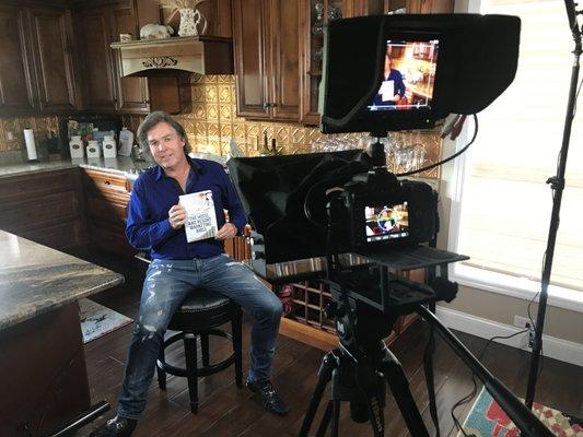 Shooting a promotional video for a client showcasing their new book.