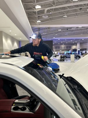 A technician from Berger Mobile Detailing preparing vehicles for the Washington Auto Show.