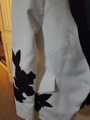 Brand new never been worn White House Black Marker blazer damaged by Dacula Cleaners.