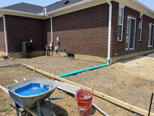 Drain placed under concrete patio