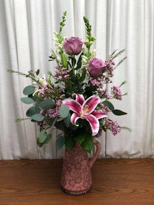 Lilies and roses look striking with a touch of eucalyptus. One of our custom bouquets.