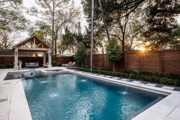 Rectangular pool with deck jets and outdoor living area