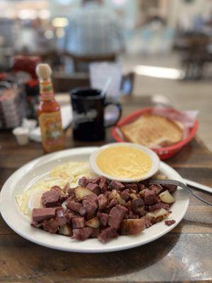 Corned beef hash with fried eggs and toast