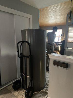 Delta technician preparing to take our new water heater down to the basement.