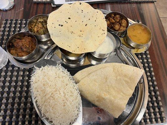 Veggie Thali. Sorry y'all I should have moved the papadum. It's hiding 3 more small dishes.