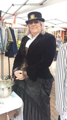 Vendor promoting and selling period costumes