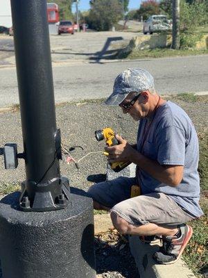 One of our technicians working on torubleshooting an outdoor commercial post light