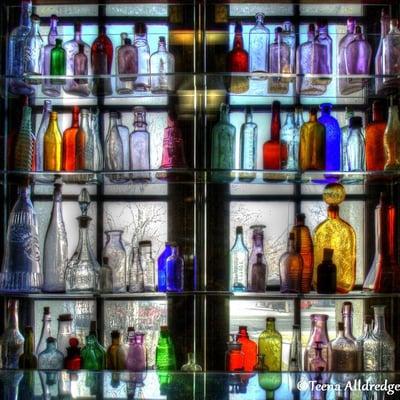 Colored glass bottles in the window.