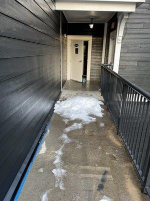 Snow and ice piled and blocking walkway.