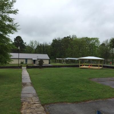 Stage under construction?  Picnic pavilion across street beyond it.  Looking south.