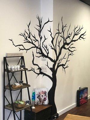 Inside the CBD solutions retail location. Hand painted tree of life.