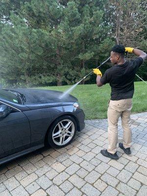 A Mercedes Benz c300 being pressure washed by our green works pressure washer.