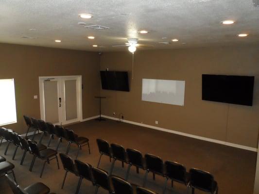 Two large LED TVs for presentation or video presentations.  Large glass dry erase whiteboard