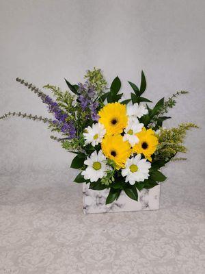 Yellow gerbera daisies, white daisies and purple Veronica and solidago.