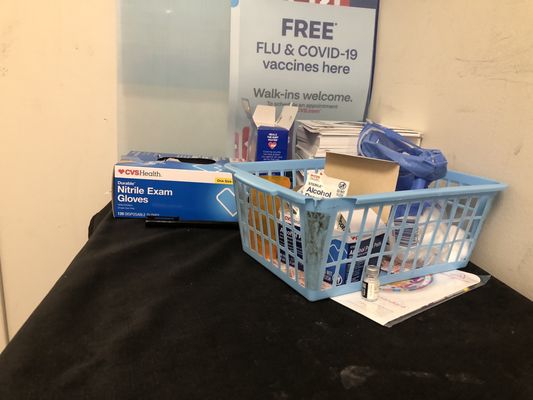 Filthy tablecloth, broken filthy basket, empty used vaccine bottle.