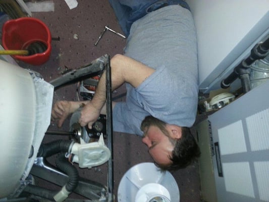 Joe installing a transmission in a washer.