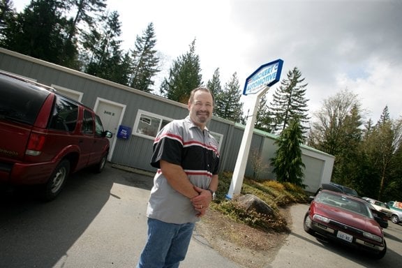 Howard in front of shop.