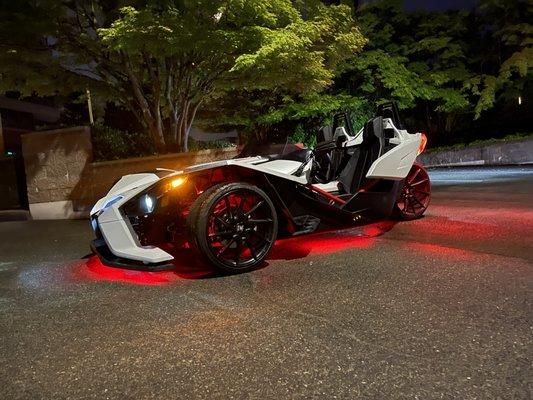 Polaris slingshot dropped on coil-overs with savini wheels, headers, and exhaust.