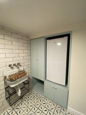 Laundry room with room for stand-up freezer. Note the beautiful custom cabinetry and new sink.