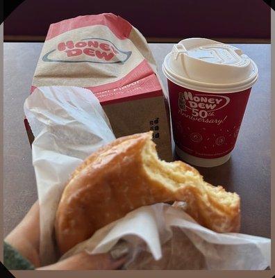 A glaze donut and hot chocolate