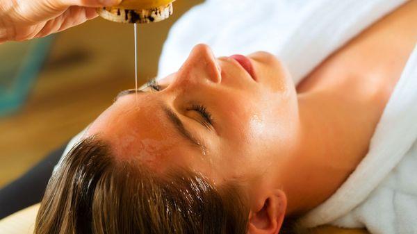 Shirodhara - pouring a continuous stream of warm organic oil on the forehead brings relief from stress and quietens the mind.