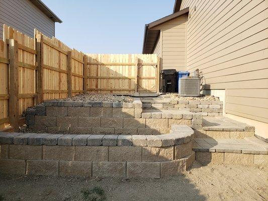 Block walls, steps and path with 6ft. cedar privacy fence.