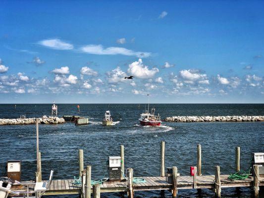 The red boat on the right is the vessel used for parasailing, here heading into the sound to begin a parasailing trip.