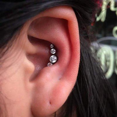 Conch piercing with a cluster