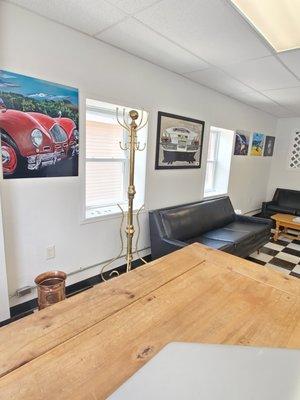 Collection of automotive artwork to admire or buy. Visit us today for a haircut!