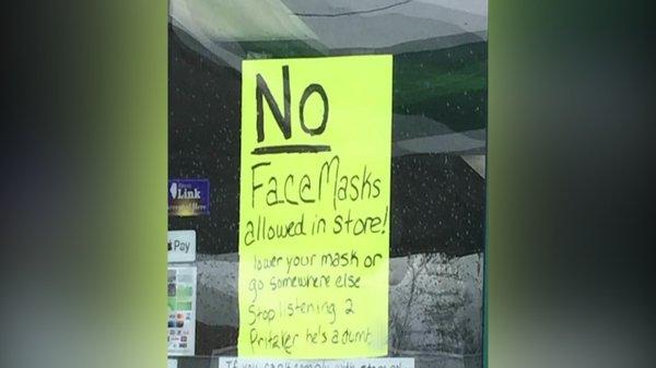 Sign posted on door of BP Gas Station.