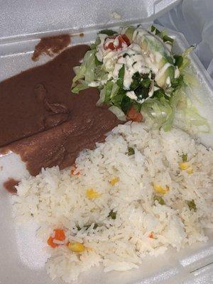 Rice beans and salad topped with avocado