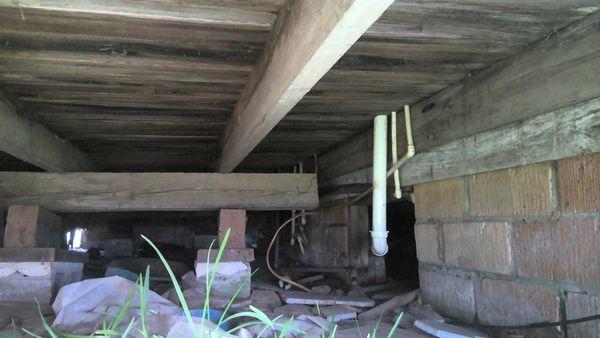 pvc drain pipe blocking entrance to crawl space along with having unlevel climb uphill to exit so it will not drain properly