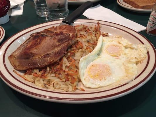 2 Pork Chops and 2 eggs hash browns and toast $9.29 delicious