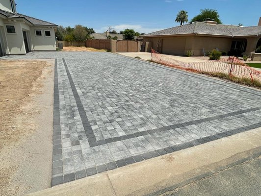 Very clean & modern look to this driveway. We used a "Phoenix Paver Slate" bordered  with a "Charcoal" to match the color scheme of the home