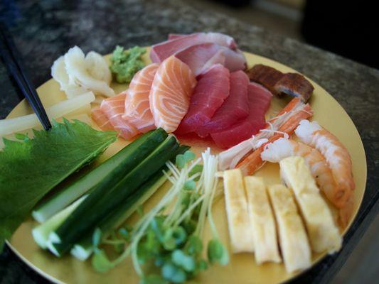 Ingredients for one person to make hand rolls - sashimi cuts, tamago, cucumber, daikon sprouts, shiso leaf, imitation crab, unagi, shrimp