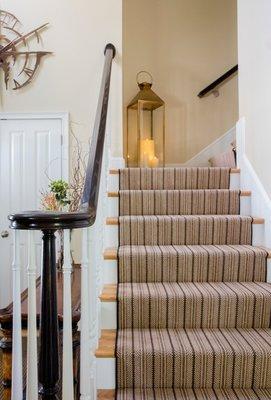 A striped wool sisal runner adds the perfect element to the entrance foyer,