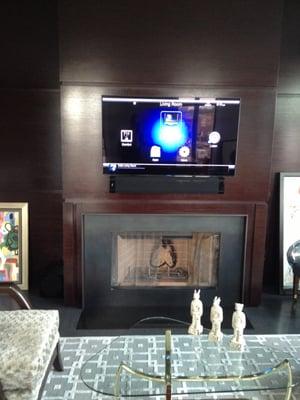 TV install over fireplace with all gear hidden in a closet.