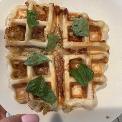 Savory Pizza Waffle made with pizza dough garlic butter, pepperoni, Mozzarella cheese, and fresh basil. Served with a side of marinara sauce