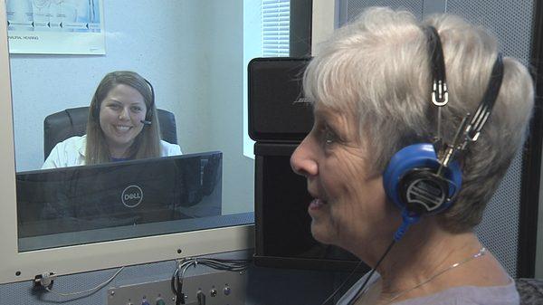 Audiologist conducting a hearing exam.