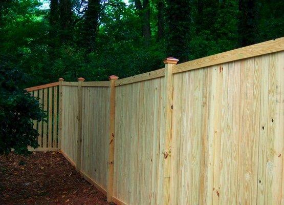 Cedar Trim from post to post, with custom made redwood caps.