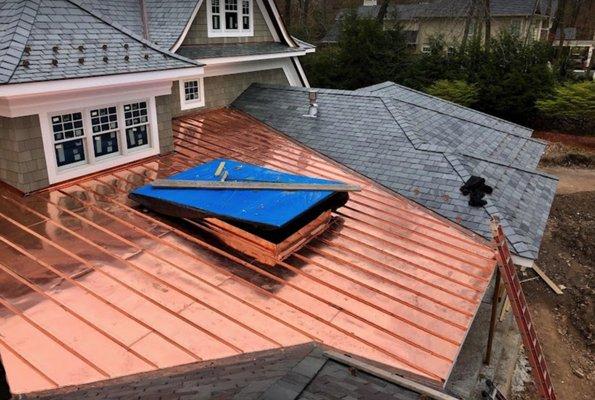 Slate roof with copper roofing (standing seam) and skylight