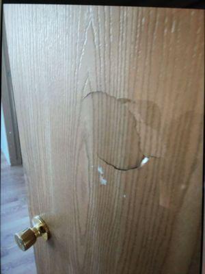 This is one of the bedroom or bathroom door.   Previous tenants son punched it out of frustration.