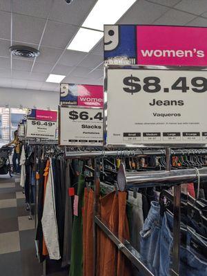 Racks of women's clothes with pricing