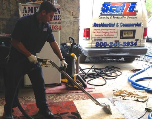 Owner Ben Scalzo cleaning a rug!