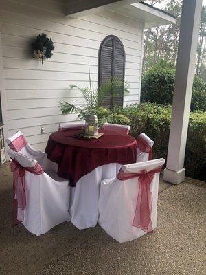 Table set up in pavilion for reception burgundy color scheme