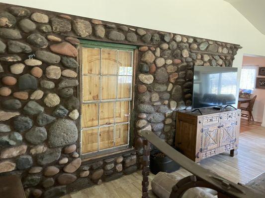 Exposing a hidden rock wall and making it a center piece of the room