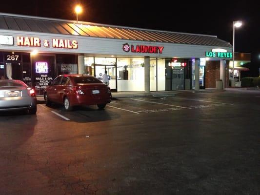 Front view, next to other stores on strip mall.