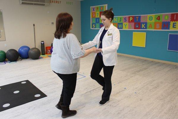 Demonstrating the single-leg balance test for a patient.